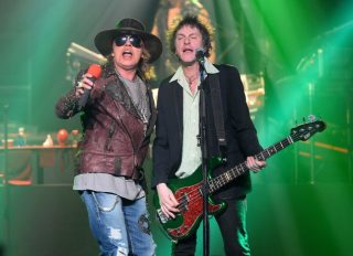 LAS VEGAS, NV - MAY 21: Singer Axl Rose (L) and bassist Tommy Stinson of Guns N' Roses perform at The Joint inside the Hard Rock Hotel &amp; Casino during the opening night of the band's second residency, "Guns N' Roses - An Evening of Destruction. No Trickery!" on May 21, 2014 in Las Vegas, Nevada. (Photo by Ethan Miller/Getty Images)