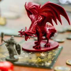 D&D on TV, Dragon, human, person and dice by Clint Bustrillos on UnSplash